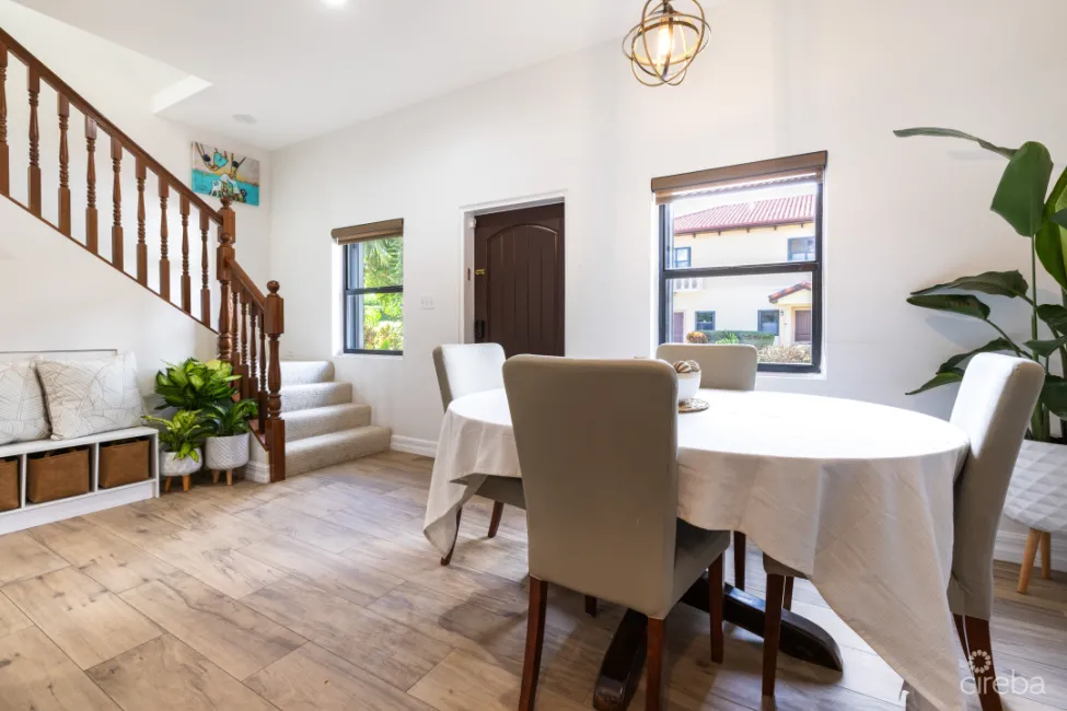 Dining area with stairs leading to bedrooms